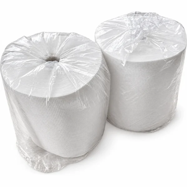 Two white pearl-embossed disposable nonwoven hair-drying towel rolls, individually wrapped in clear plastic bags and arranged against a white background.