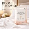00ae576e-26a4-45ff-85c1-a74b4a303f94 Individually packed disposable bath towel, hotel room scene